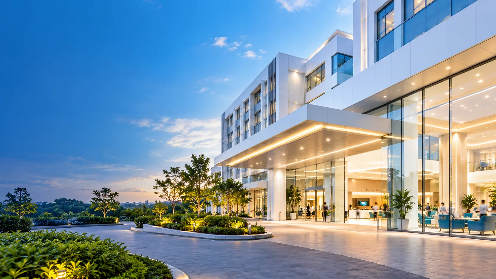 Contemporary hospital architecture with an illuminated patient entrance and landscaped campus